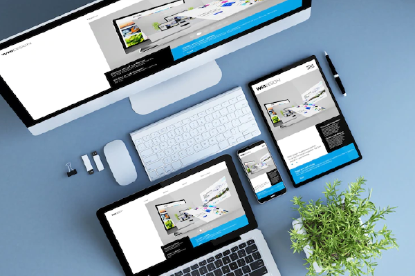 A photo of a computer screen, a tablet and a mobile phone showing a sample webpage.