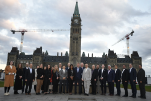 A photo of AIA Canada representatives standing in front of the Parliament Building in Ottawa