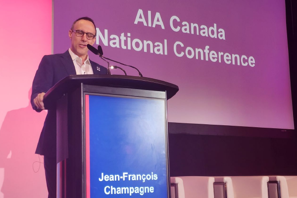 A photo of AIA Canada President Jean-Francois Champagne standing in front of a lectern, speaking at the AIA Canada National Conference.